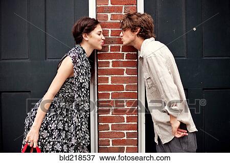 Stock Photo - Couple puckering in doorways. Fotosearch
