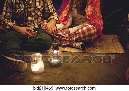 Couple relaxing in camping tent at night View Large Photo Image Stock Photo - Couple relaxing in camping tent at night. Fotosearch