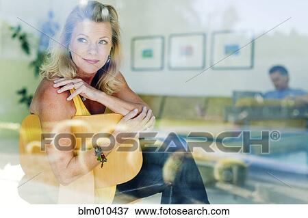 Stock Photo - Couple relaxing together in living room. Fotosearch