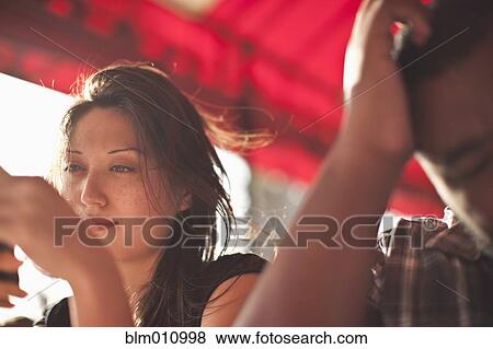 Couple sitting together in restaurant View Large Photo Image Stock Photo - Couple sitting together in restaurant. Fotosearch