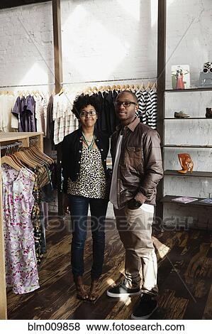 Couple standing together in clothing store View Large Photo Image Stock Photo - Couple standing together in clothing store. Fotosearch