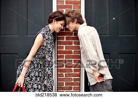 Stock Photo - Couple touching foreheads in doorways. Fotosearch