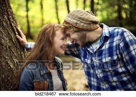 Couple touching foreheads in forest View Large Photo Image Stock Photo - Couple touching foreheads in forest. Fotosearch