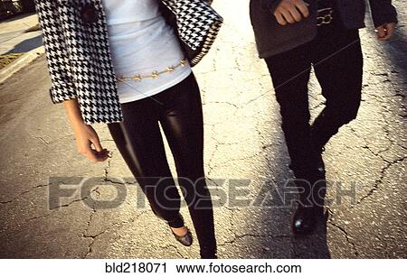 Stock Image - Couple walking on cracked street. Fotosearch