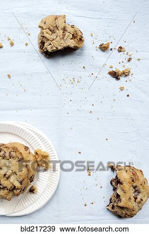 Crumbling cookies and paper plates View Large Photo Image Stock Photo - Crumbling cookies and paper plates. Fotosearch