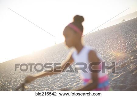 Defocused view of girl riding bicycle on beach View Large Photo Image Stock Image - Defocused view of girl riding bicycle on beach. Fotosearch