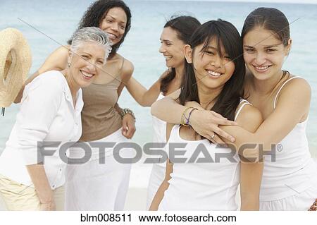 Diverse women standing on beach together View Large Photo Image Stock Image - Diverse women standing on beach together. Fotosearch