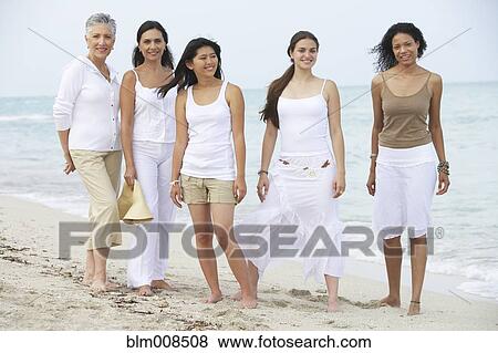 Diverse women standing on beach together View Large Photo Image Stock Photo - Diverse women standing on beach together. Fotosearch