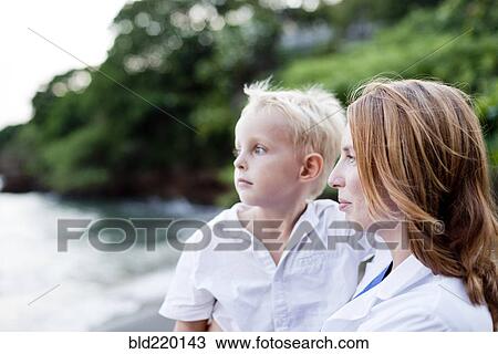 Stock Image - Doctor and son admiring ocean. Fotosearch