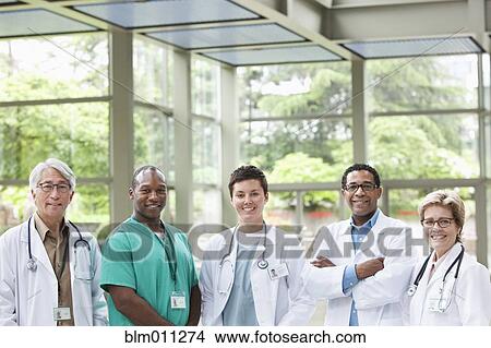 Picture - Doctors standing together in lobby. Fotosearch