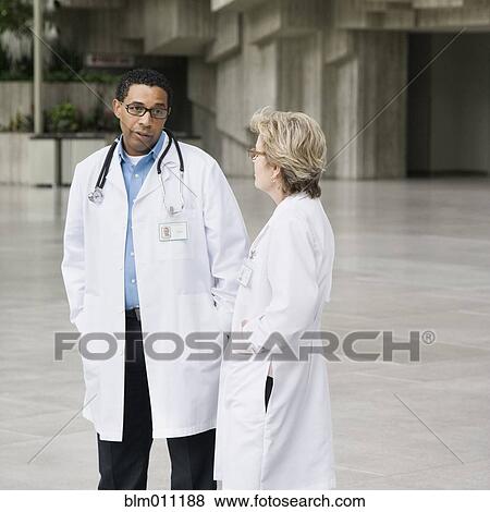 Doctors talking together in lobby View Large Photo Image Stock Photo - Doctors talking together in lobby. Fotosearch