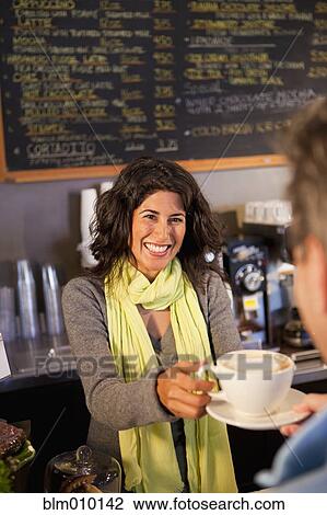 Ecuadorian woman serving customer coffee in cafe View Large Photo Image Stock Image - Ecuadorian woman serving customer coffee in cafe. Fotosearch