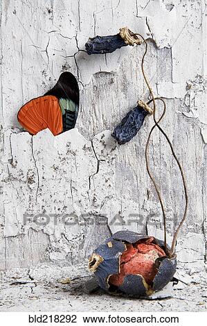 Stock Image - Egg in cracked shell under dilapidated wall and butterfly. Fotosearch