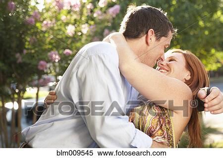 Stock Photography - Elegant Caucasian couple hugging. Fotosearch