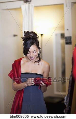 Elegant mixed race woman trying on evening gown View Large Photo Image Stock Photography - Elegant mixed race woman trying on evening gown. Fotosearch