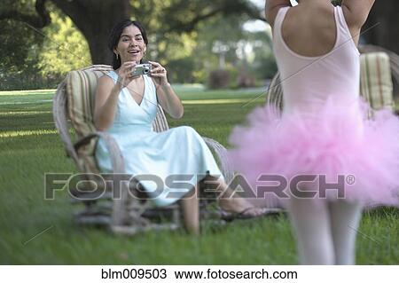 Stock Image - Elegant mother photographing ballerina daughter. Fotosearch