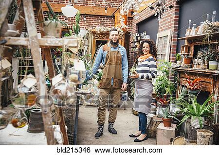 Stock Photograph - Employees smiling in plant nursery. Fotosearch