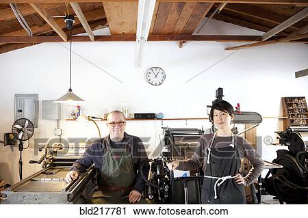 Entrepreneurs smiling in print shop View Large Photo Image Stock Image - Entrepreneurs smiling in print shop. Fotosearch