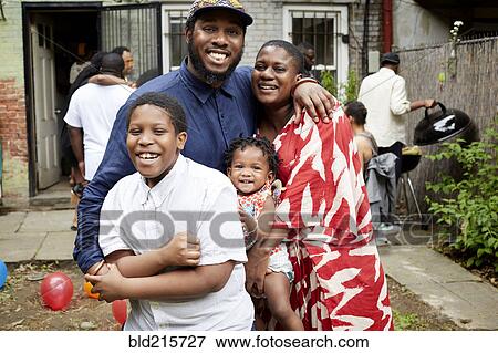 Family hugging at backyard barbecue View Large Photo Image Stock Photo - Family hugging at backyard barbecue. Fotosearch
