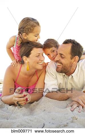 Family laying on beach together View Large Photo Image Stock Image - Family laying on beach together. Fotosearch