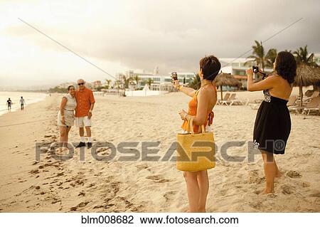 Family on beach vacation taking photographs View Large Photo Image Stock Image - Family on beach vacation taking photographs. Fotosearch