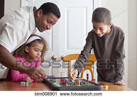 Family playing board game together View Large Photo Image Stock Image - Family playing board game together. Fotosearch