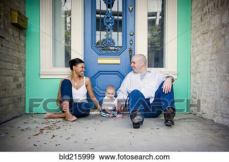 Stock Photo - Family sitting in doorway. Fotosearch