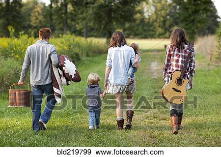 Stock Photo - Family walking in rural field. Fotosearch