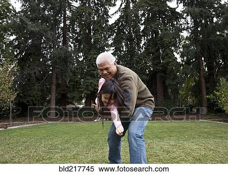 Father and daughter playing in backyard View Large Photo Image Stock Photography - Father and daughter playing in backyard. Fotosearch