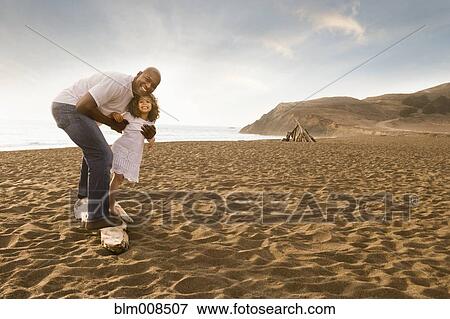 Father and daughter smiling on beach View Large Photo Image Stock Photo - Father and daughter smiling on beach. Fotosearch