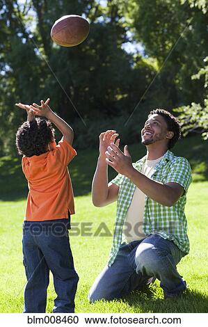 Father and son playing football View Large Photo Image Stock Image - Father and son playing football. Fotosearch