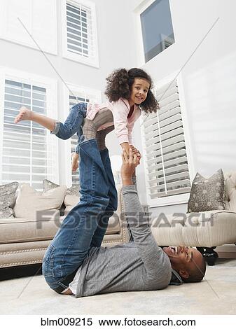 Father lifting daughter on his feet View Large Photo Image Stock Photography - Father lifting daughter on his feet. Fotosearch