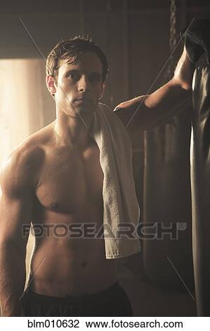 Fatigued boxer leaning on punching bag View Large Photo Image Stock Image - Fatigued boxer leaning on punching bag. Fotosearch
