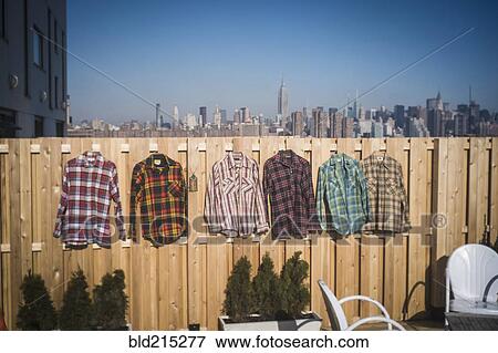 Stock Photo - Flannel shirts hanging to dry in urban backyard, New York, New York, United States. Fotosearch