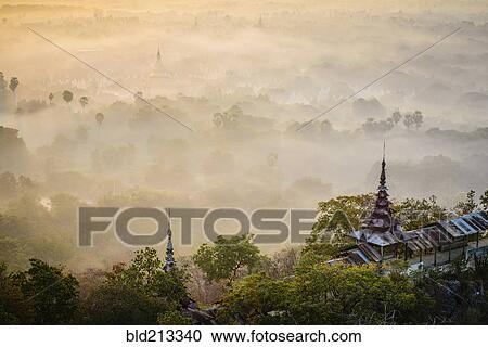 Stock Image - Fog over treetops, Mayanmar, Mandalay, Myanmar. Fotosearch
