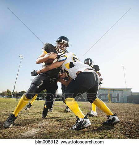 Football player tackling player on football field View Large Photo Image Stock Image - Football player tackling player on football field. Fotosearch