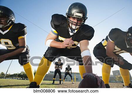 Football players crouching on football field View Large Photo Image Stock Photograph - Football players crouching on football field. Fotosearch