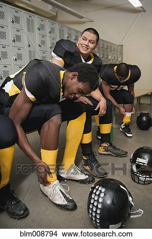 Picture - Football players dressing in locker room. Fotosearch