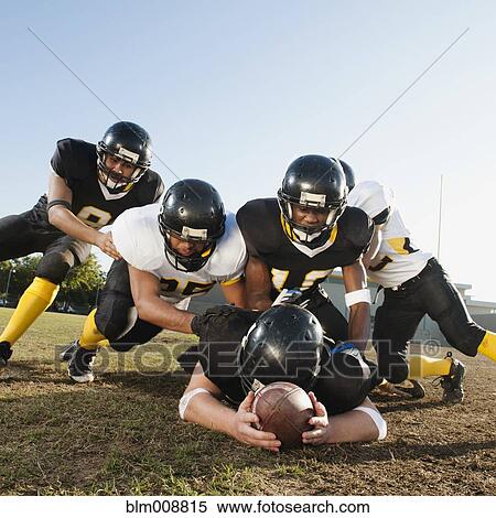 Football players tackling player on football field View Large Photo Image Stock Photography - Football players tackling player on football field. Fotosearch