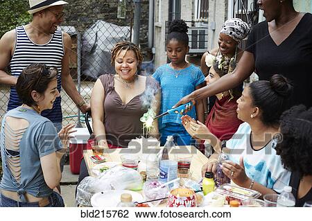 Friends celebrating birthday party in backyard View Large Photo Image Stock Image - Friends celebrating birthday party in backyard. Fotosearch