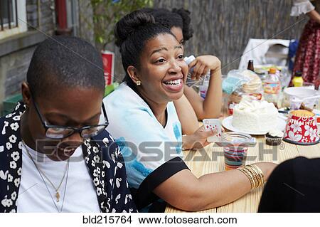 Picture - Friends enjoying backyard party. Fotosearch