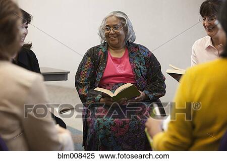 Stock Photography - Friends enjoying book club. Fotosearch