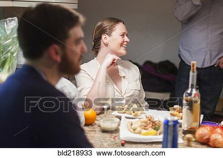 Stock Image - Friends enjoying dinner party. Fotosearch