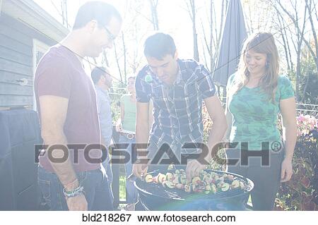 Friends grilling vegetables in backyard View Large Photo Image Stock Photo - Friends grilling vegetables in backyard. Fotosearch