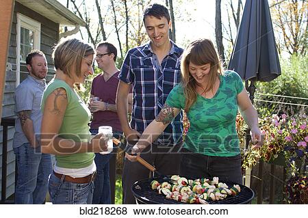 Friends grilling vegetables in backyard View Large Photo Image Stock Photo - Friends grilling vegetables in backyard. Fotosearch
