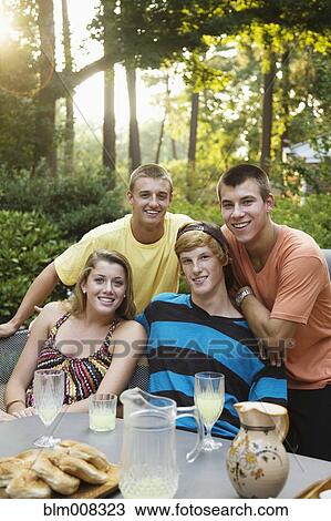 Stock Image - Friends hanging out together drinking lemonade. Fotosearch