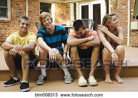 Friends hanging out together on patio View Large Photo Image Stock Image - Friends hanging out together on patio. Fotosearch