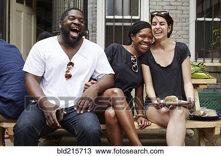 Friends laughing at backyard barbecue View Large Photo Image Stock Image - Friends laughing at backyard barbecue. Fotosearch