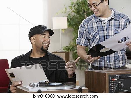 Stock Image - Friends listening to music together. Fotosearch
