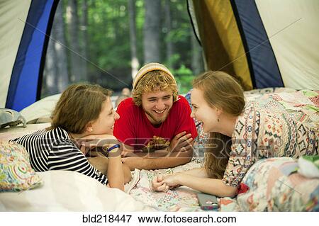 Friends relaxing in camping tent View Large Photo Image Stock Photo - Friends relaxing in camping tent. Fotosearch
